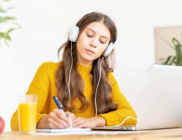 happy-female-in-wireless-headphones-studying-onlin-2021-08-29-15-15-41-utc.jpg